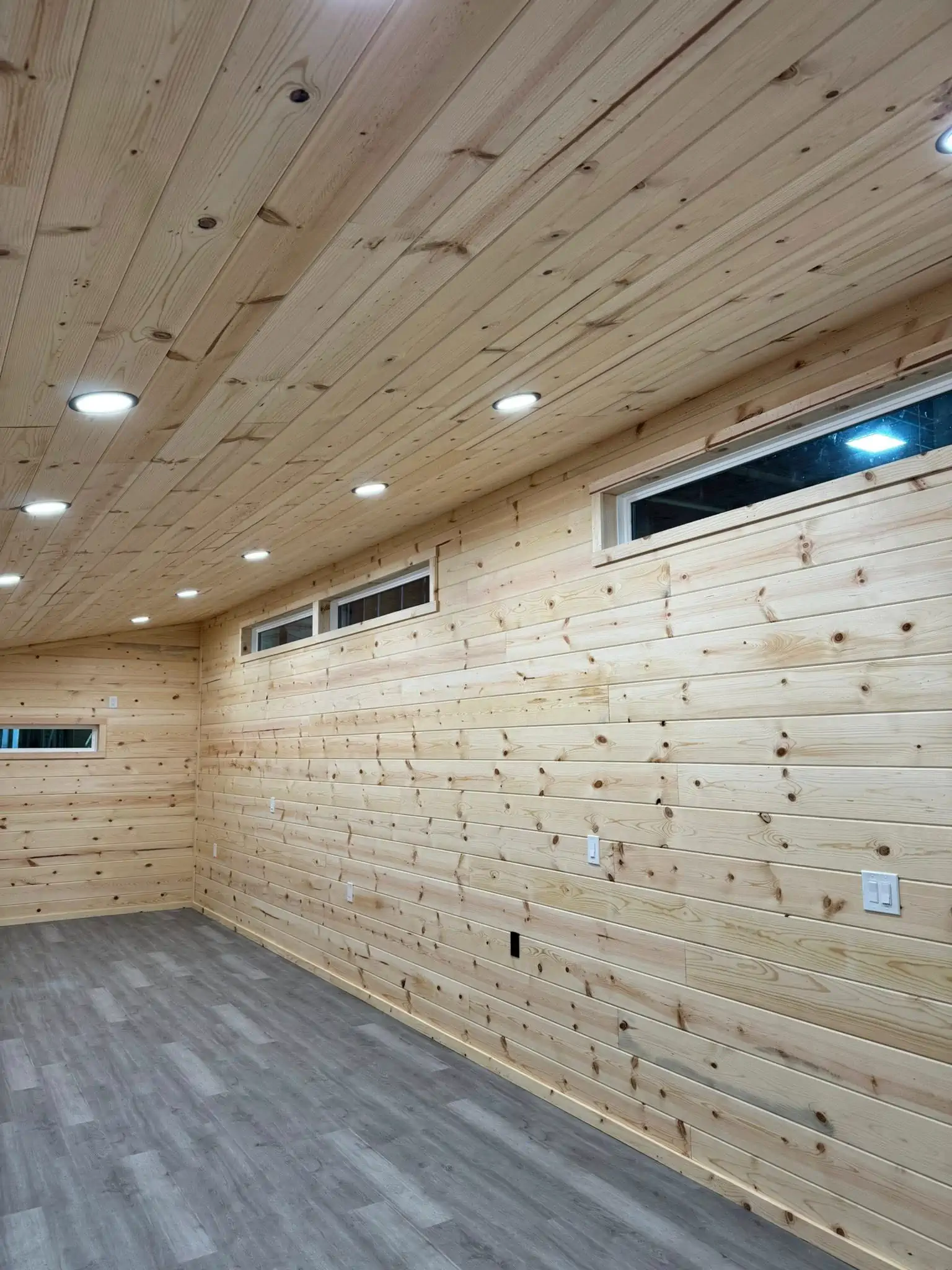 Interior of a modern shed converted into a home office with a desk and chair.