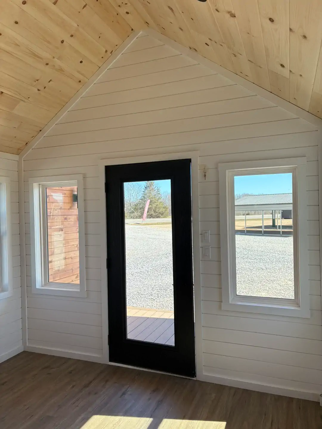 An open utility shed showcasing ample interior space and natural light.
